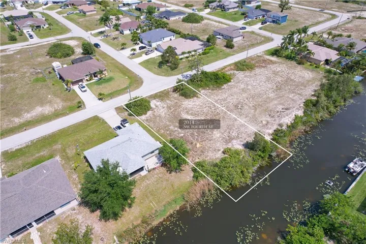Birds eye view of property with a water view