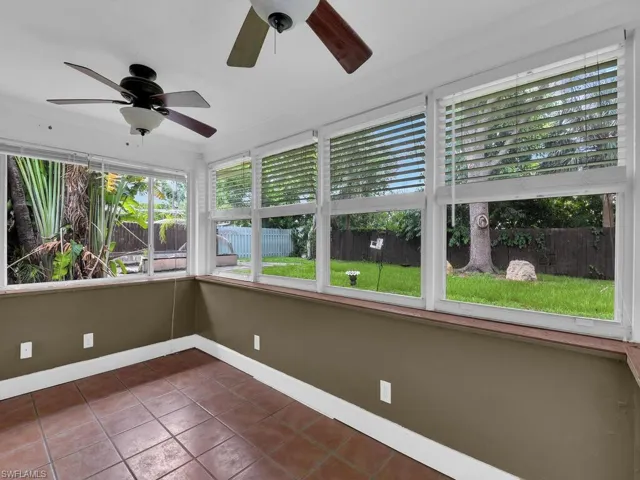 Unfurnished sunroom featuring ceiling fan
