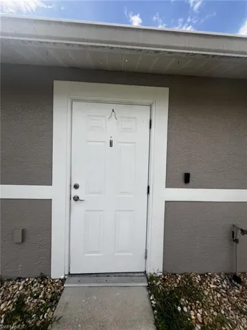 Entrance to property featuring stucco siding
