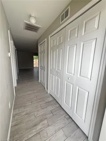 Corridor with baseboards and light wood finished floors