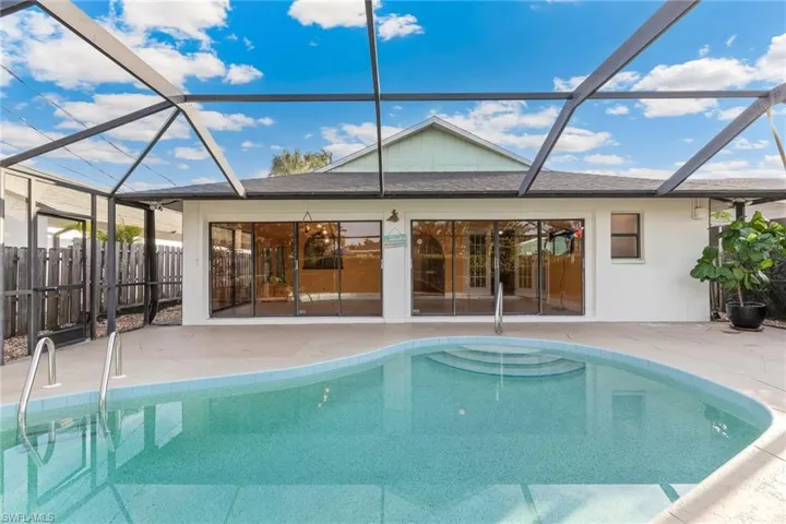View of pool with a patio and a lanai