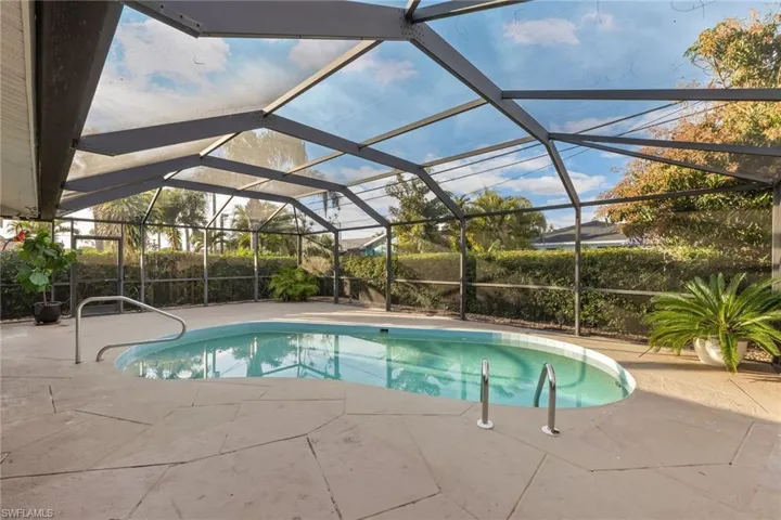 View of swimming pool with a lanai and a patio area