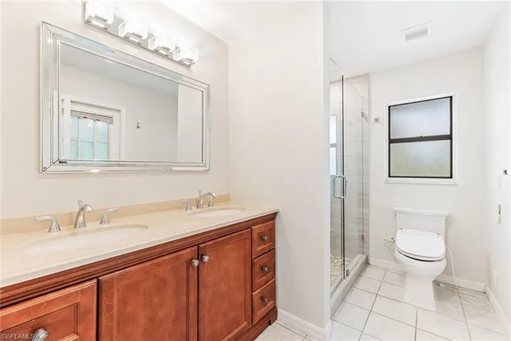 Master Bathroom featuring walk-in shower, tile patterned floors, toilet with bidet, and vanity