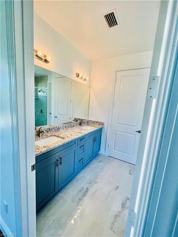 Dual sink, cabinets and many drawers with lots of storage space.