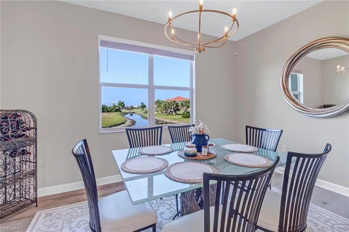 Dining space featuring a notable chandelier and light wood-type flooring