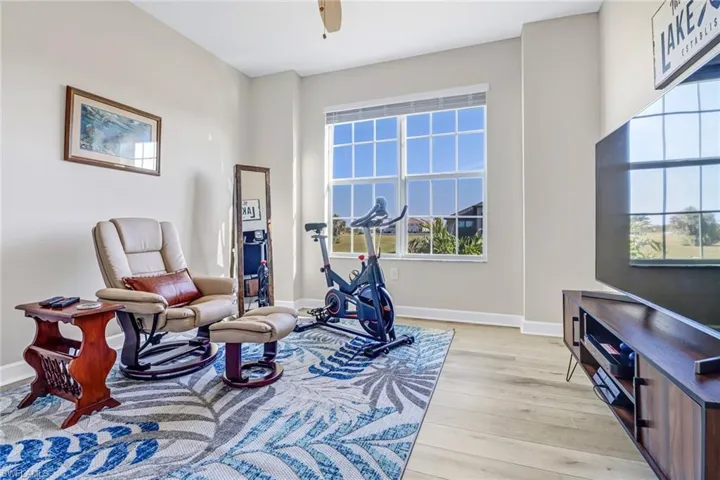 Living area with ceiling fan, light hardwood / wood-style flooring, and plenty of natural light