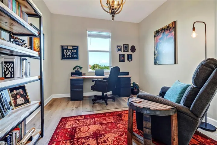 Office featuring light hardwood / wood-style flooring and a chandelier