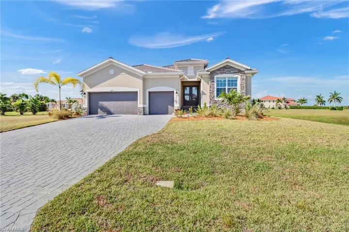 View of front of home featuring a garage and a front yard