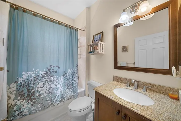 Bathroom with vanity and shower / tub combo with curtain