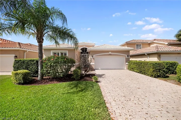 Mediterranean / spanish home featuring stucco siding, an attached garage, decorative driveway, and a tile roof