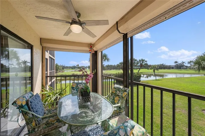 Sunroom / solarium with a water view and ceiling fan