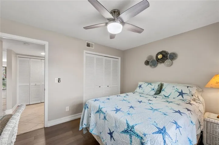 Bedroom featuring ceiling fan, a closet, and wood-type flooring