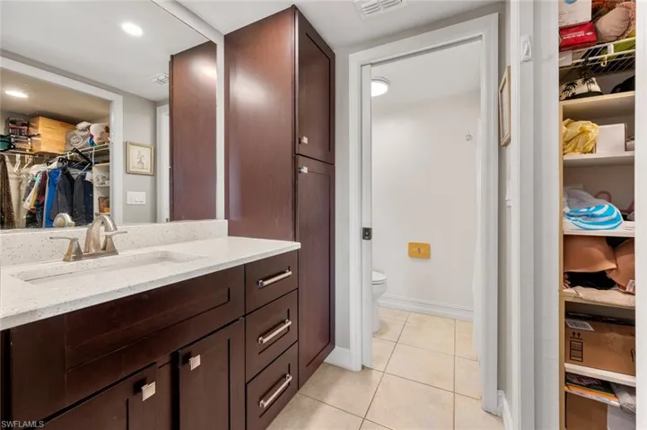 Bathroom with tile patterned flooring, vanity, and toilet