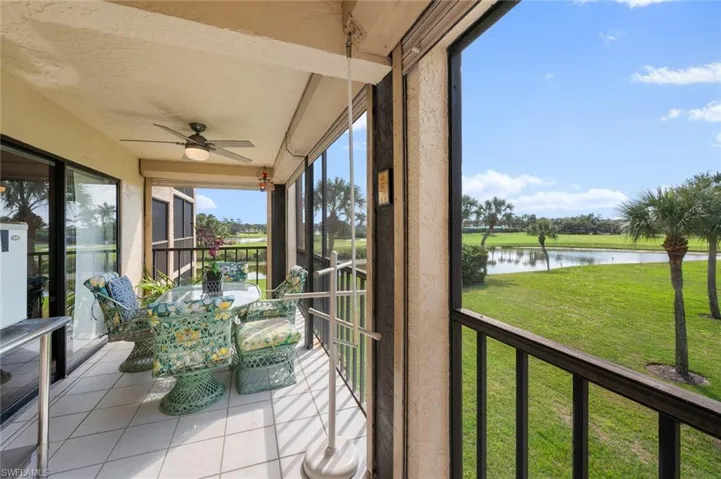 Unfurnished sunroom with a water view and ceiling fan