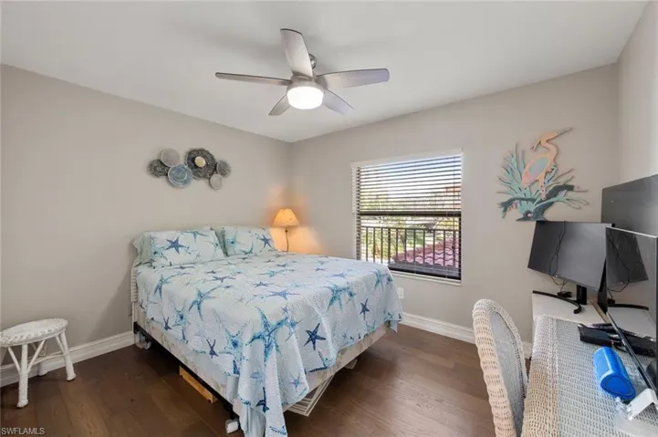 Bedroom featuring ceiling fan and dark wood-type flooring