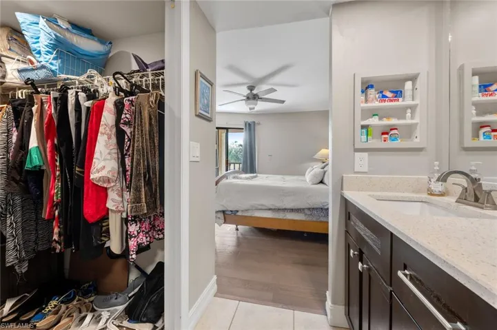 Bathroom with ceiling fan, tile patterned flooring, and vanity