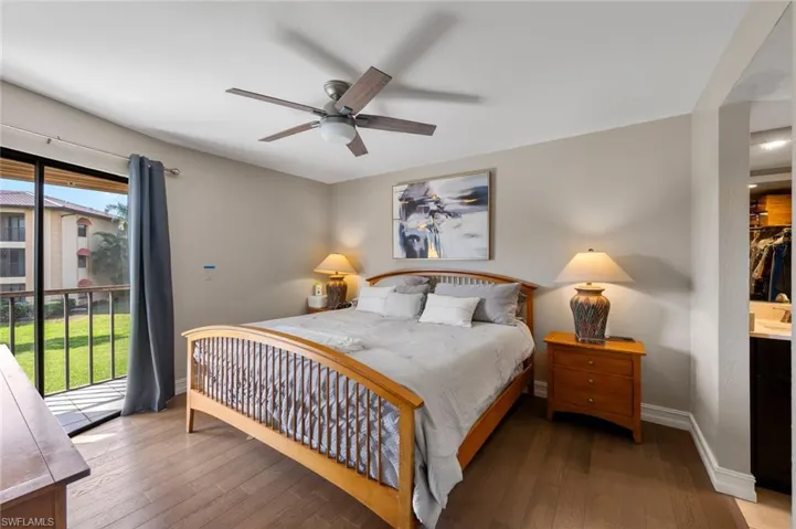 Bedroom featuring hardwood / wood-style flooring, ceiling fan, and access to exterior