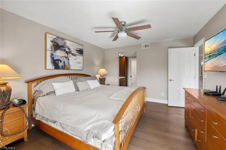 Bedroom featuring ceiling fan and dark hardwood / wood-style floors