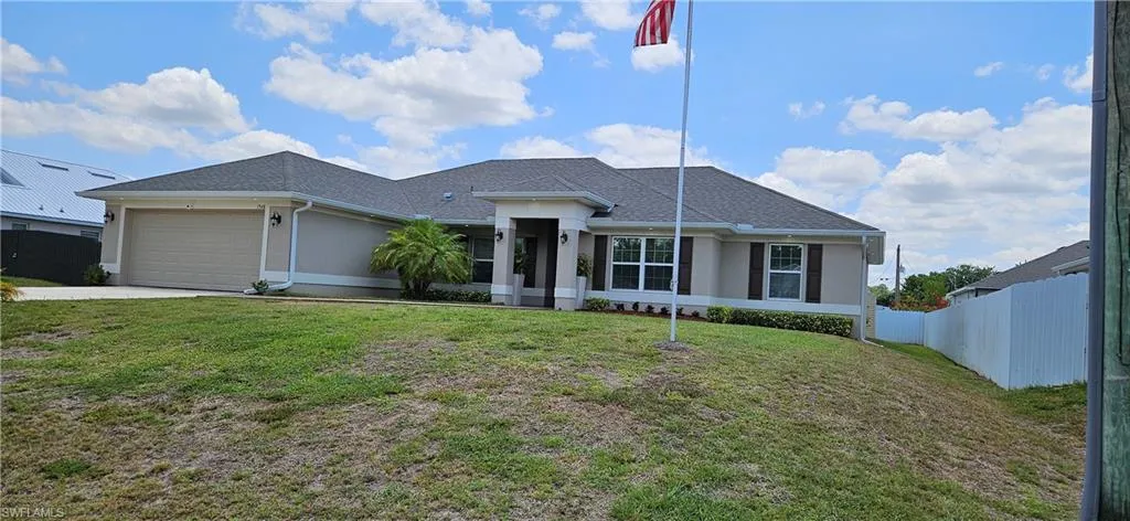 Ranch-style house with stucco siding, a garage, concrete driveway, and roof with shingles