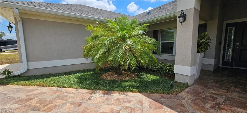 View of property exterior featuring stucco siding and roof with shingles