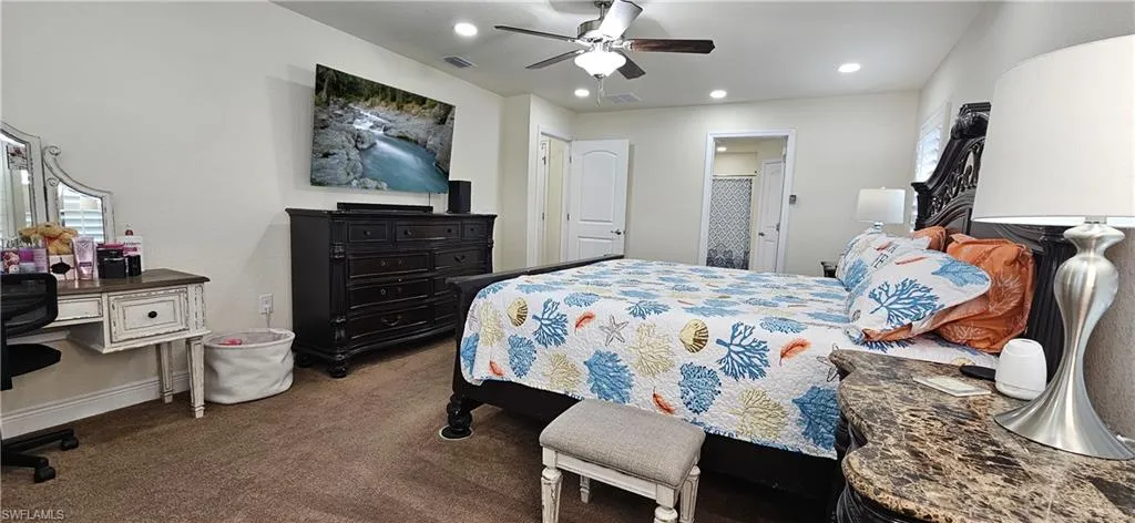 Carpeted bedroom featuring recessed lighting, baseboards, and ceiling fan