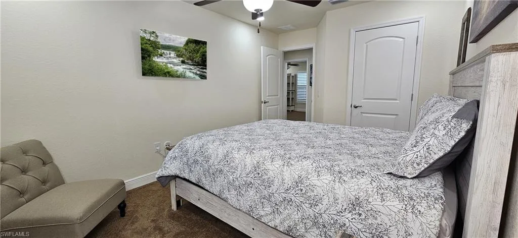 Bedroom with carpet floors, baseboards, and ceiling fan