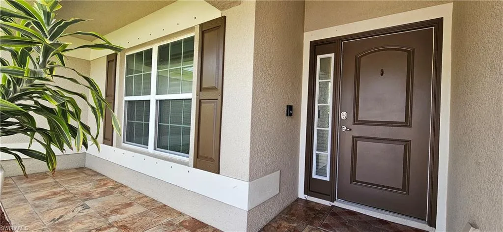 View of exterior entry featuring stucco siding