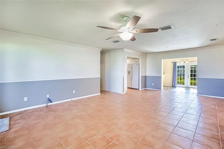 Unfurnished room with french doors, ceiling fan, crown molding, and light tile patterned flooring