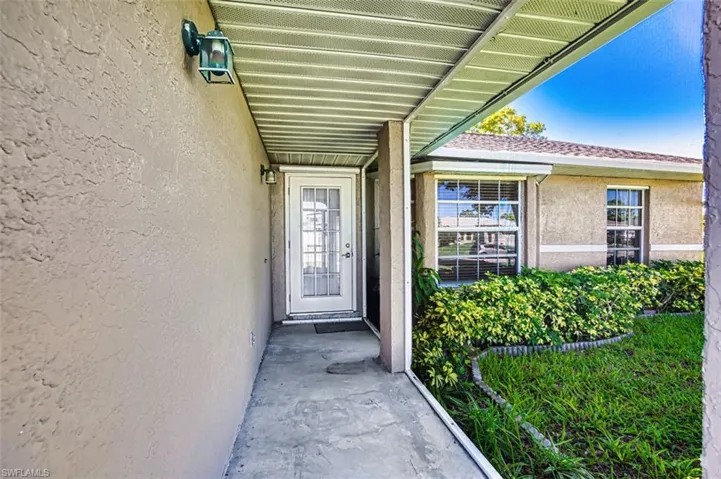 View of exterior entry featuring stucco siding