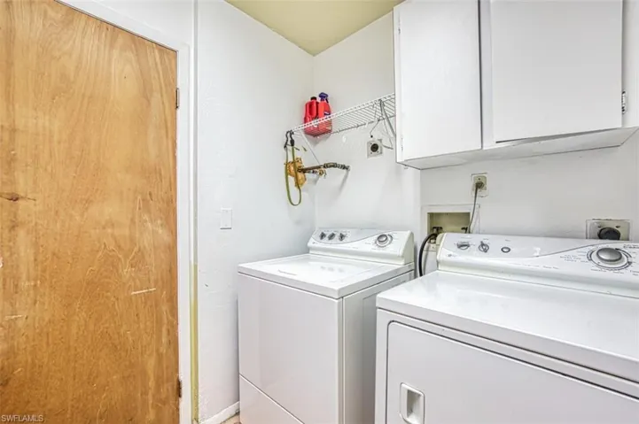 Washroom with cabinet space and washer and dryer