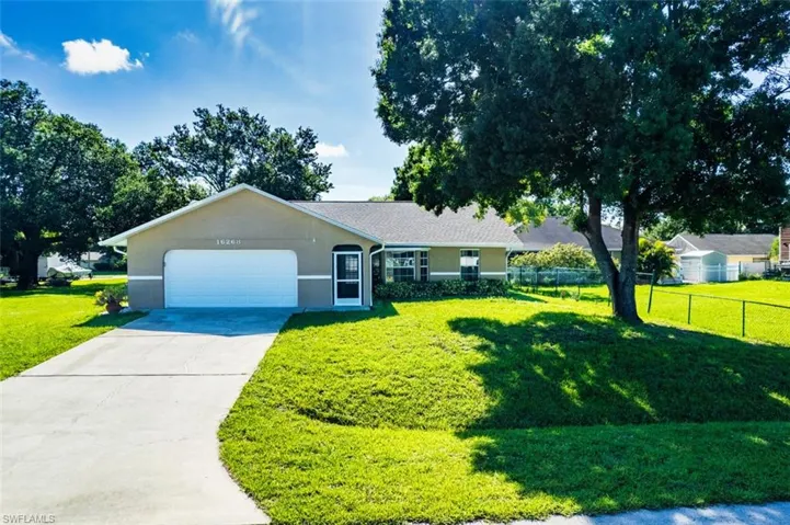 View of front of house with stucco siding, a garage, and concrete driveway