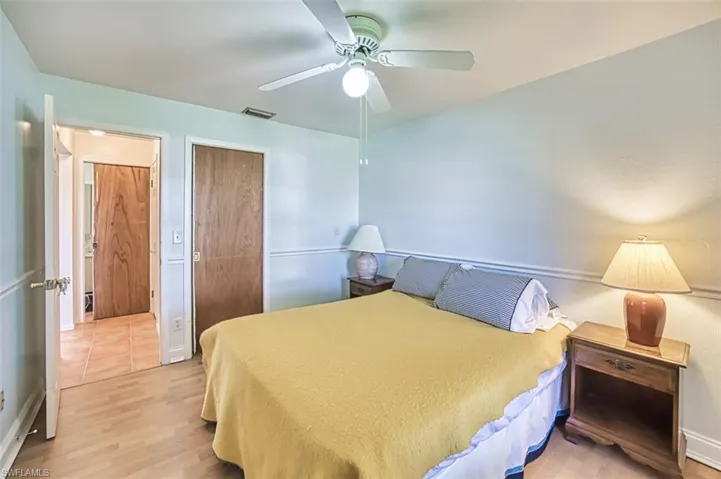 Bedroom with wood finished floors, a ceiling fan, and a closet