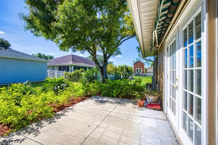 Fenced backyard featuring a patio and french doors