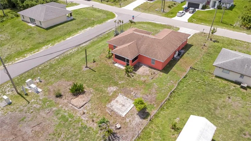 Coral-colored exterior with a brown shingle roof