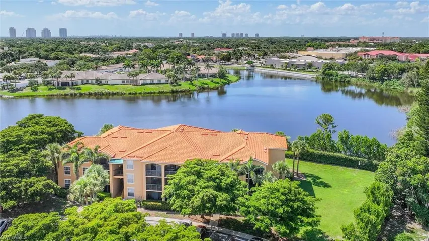 Birds eye view of property with a water view