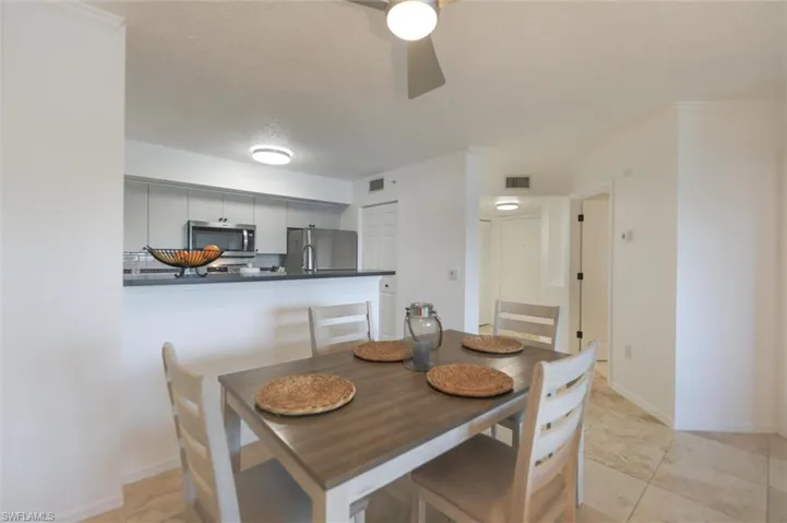 Dining space featuring light tile patterned floors and ceiling fan
