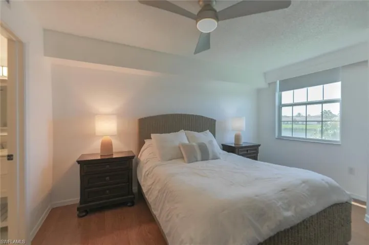 Bedroom featuring a textured ceiling, dark hardwood / wood-style flooring, and ceiling fan