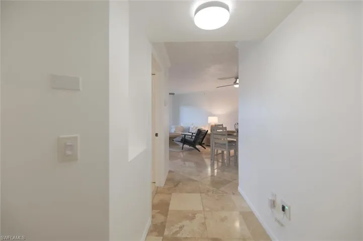 Hallway featuring light tile patterned floors