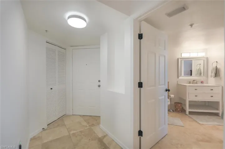 Hall with light tile patterned flooring