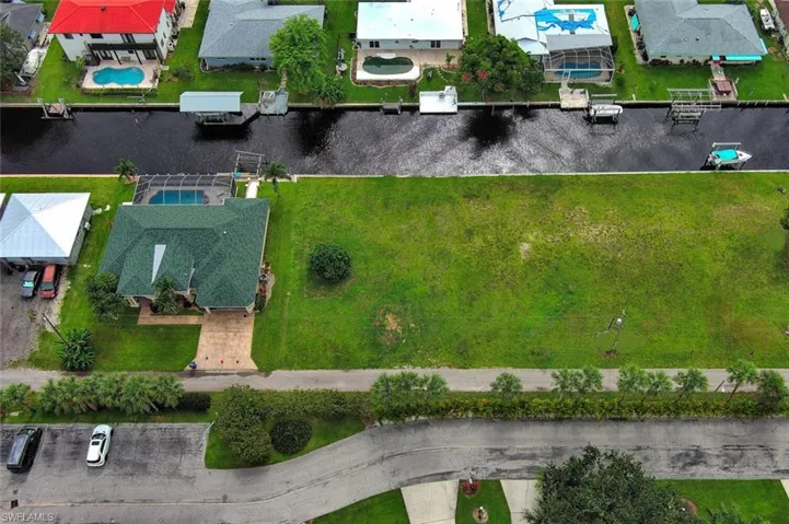 Aerial view featuring a water view and a residential view