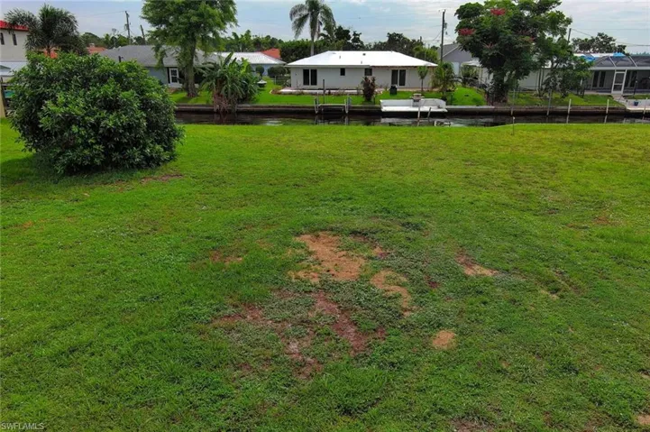 View of yard featuring a residential view and a water view