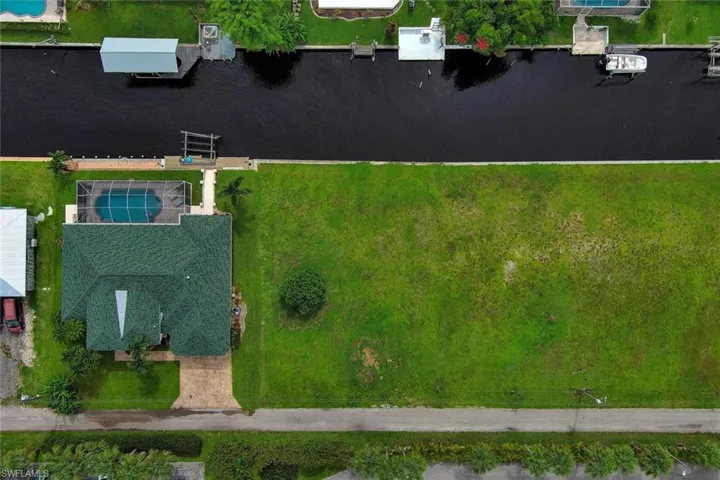 Birds eye view of property with a water view