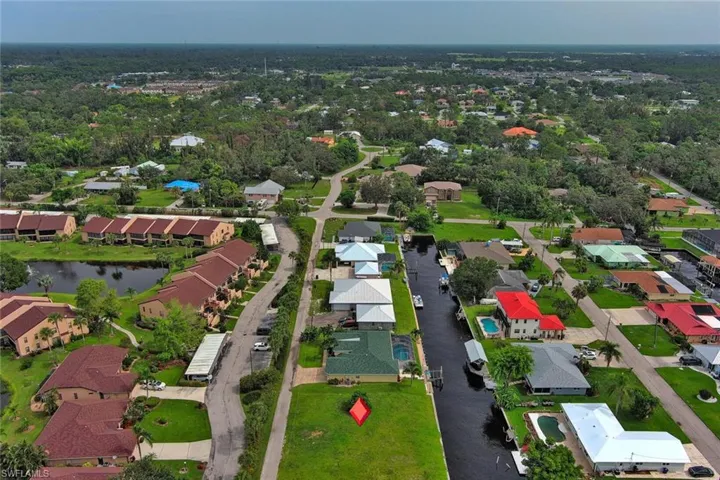 Birds eye view of property with a water view and a residential view