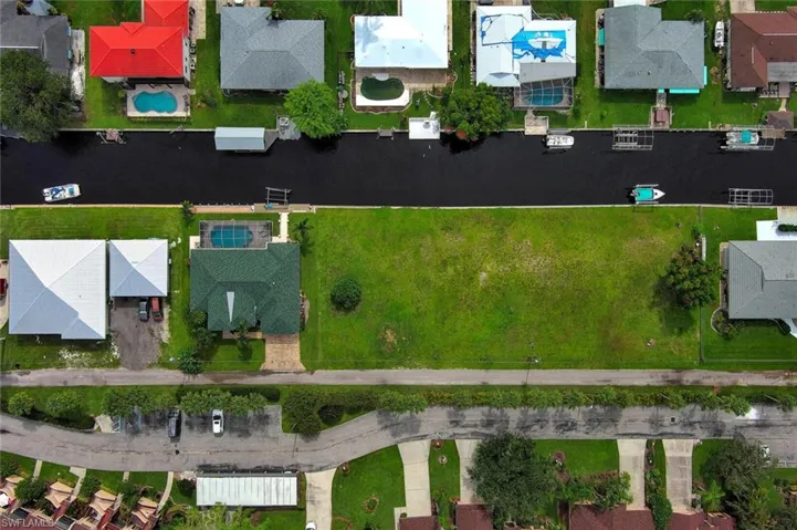 Aerial view featuring a water view and a residential view