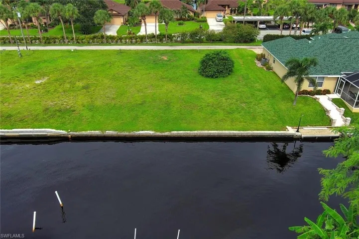 Birds eye view of property with a water view