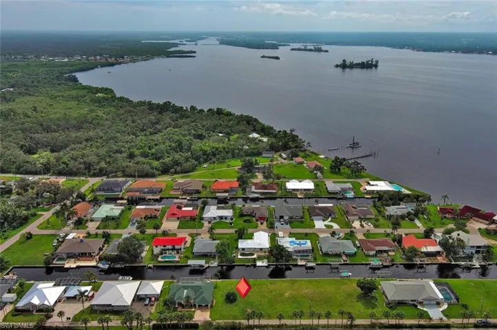 Birds eye view of property featuring a water view and a residential view