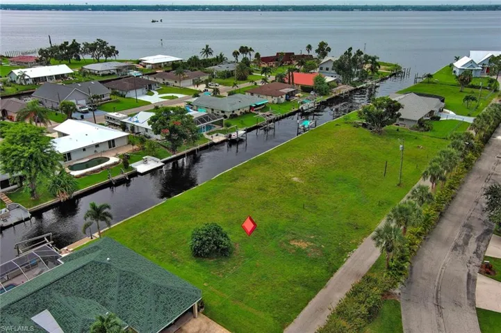 Birds eye view of property with a residential view and a water view