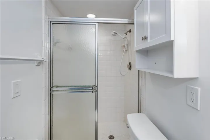 Master bathroom with toilet and a shower with shower door