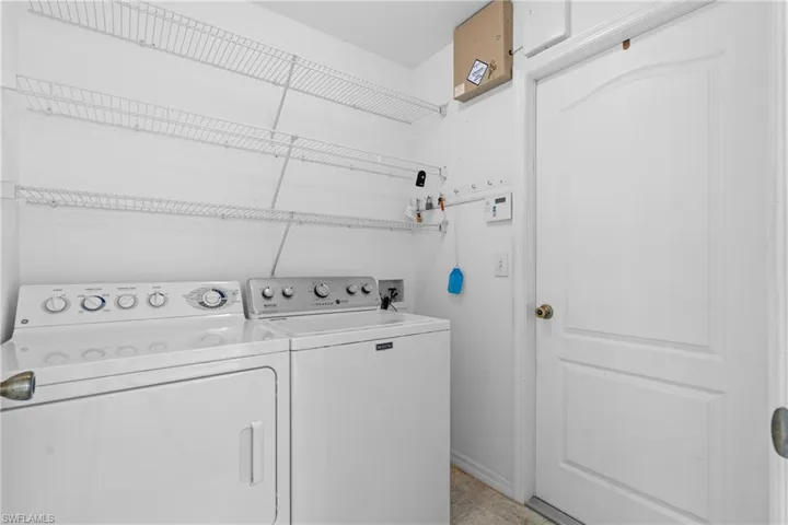 Washroom featuring washer and clothes dryer