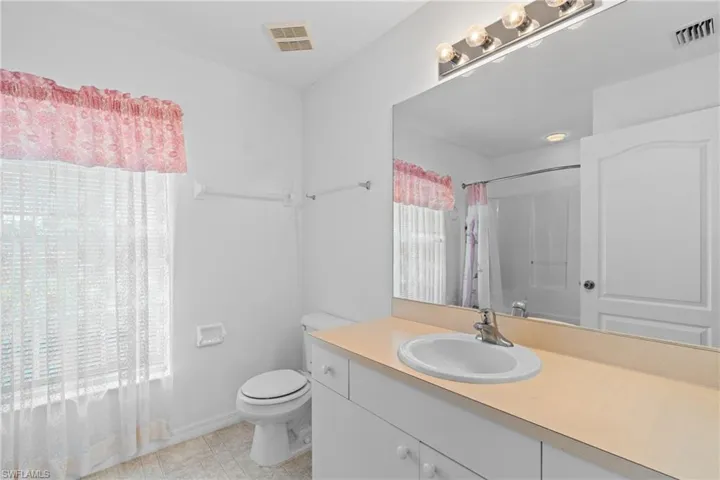 Full bathroom with vanity and curtained shower